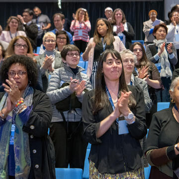 Attendees applaud at the end of the 2019 Impact Conference.